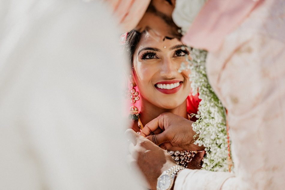 Indian bride looking at her groom during an hindu ceremony in the Greek Isle of Mykonos.